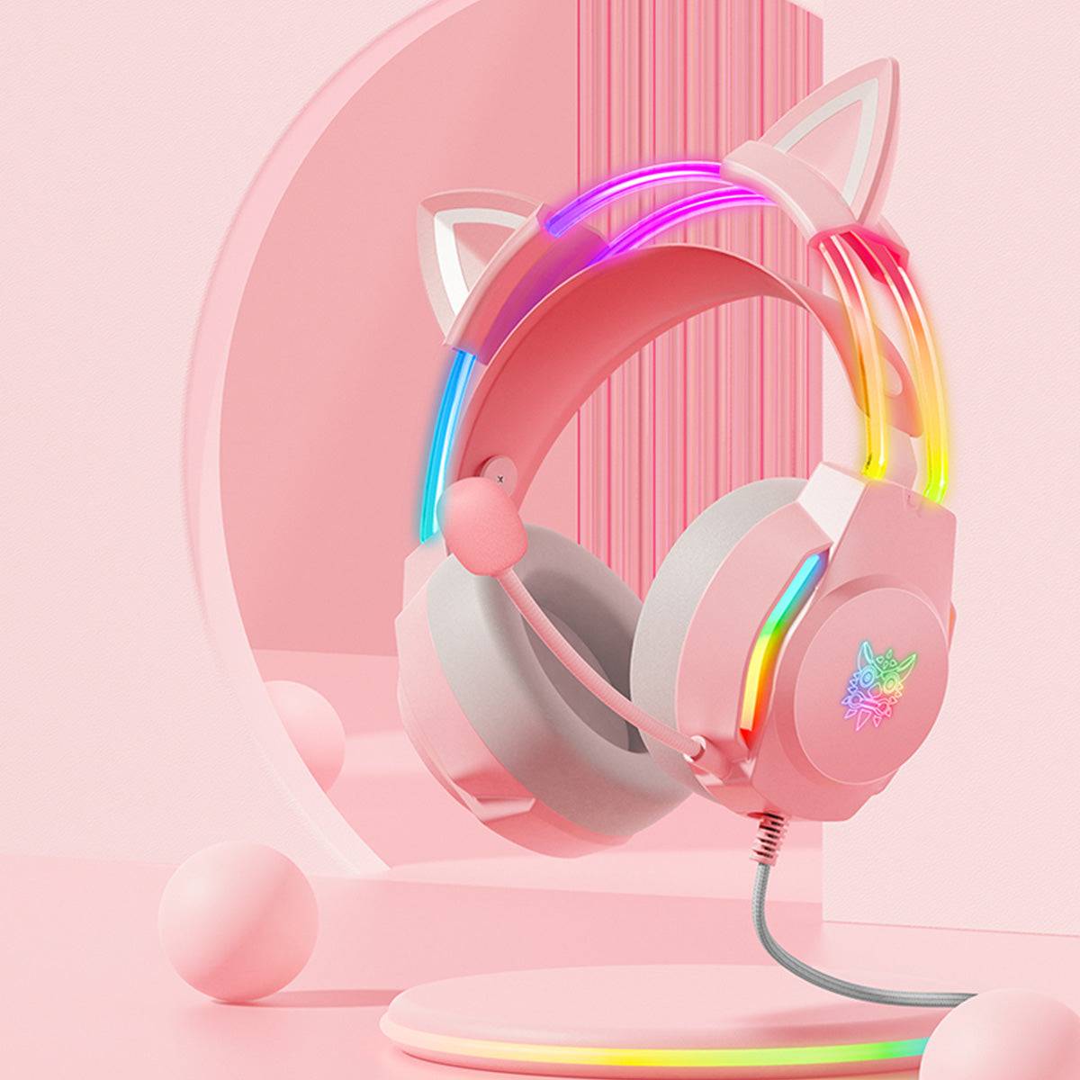 Aesthetic ONIKUMA X26 Cat Ear RGB Gaming Headset in pink, displayed on a stylish stand with glowing LED accents for a cute and modern gaming setup.